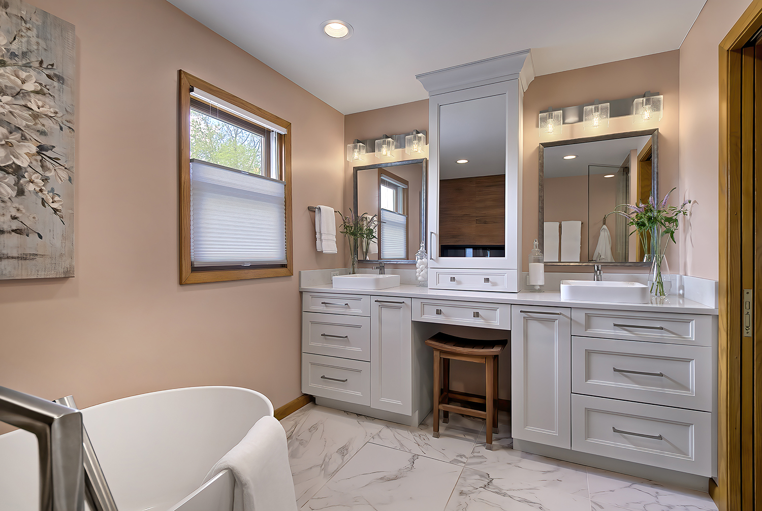 his and her vanity with center makeup station and asian-inspired bench seating