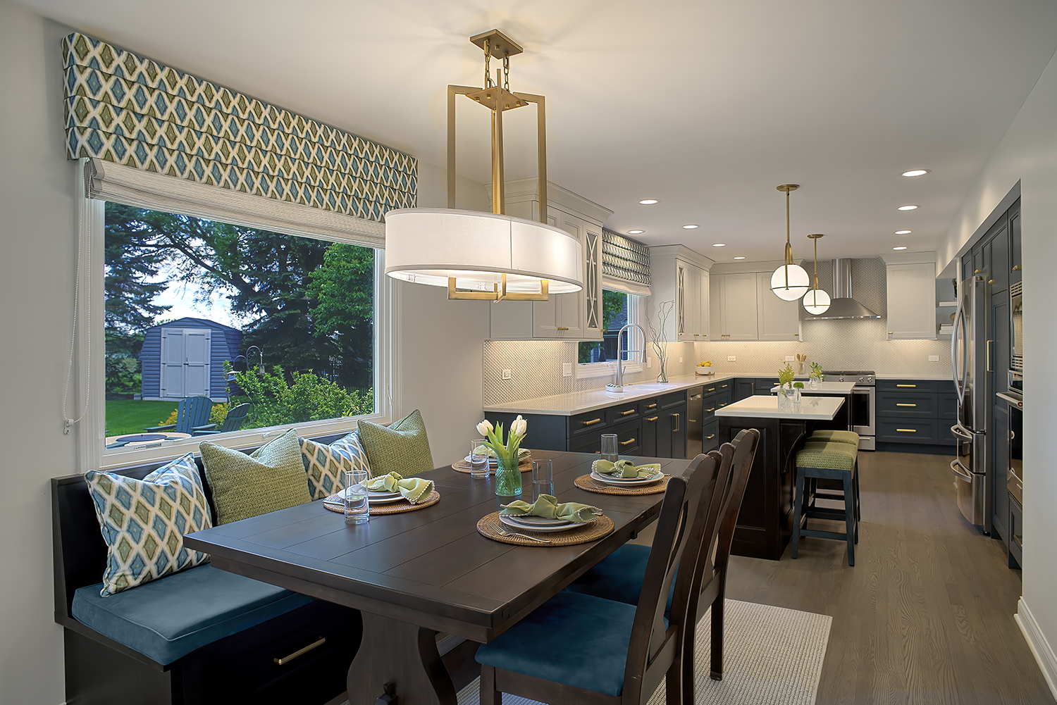 designer kitchen with colorful upholstery on chairs, banquette, and drapery